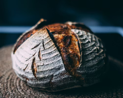 Classic artisan sourdough loaf on a cooling rack